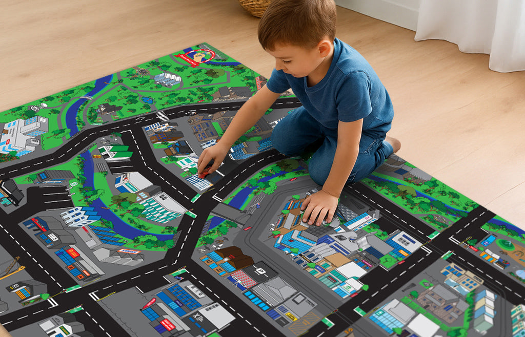 Child playing on a large city map play mat with roads and buildings.